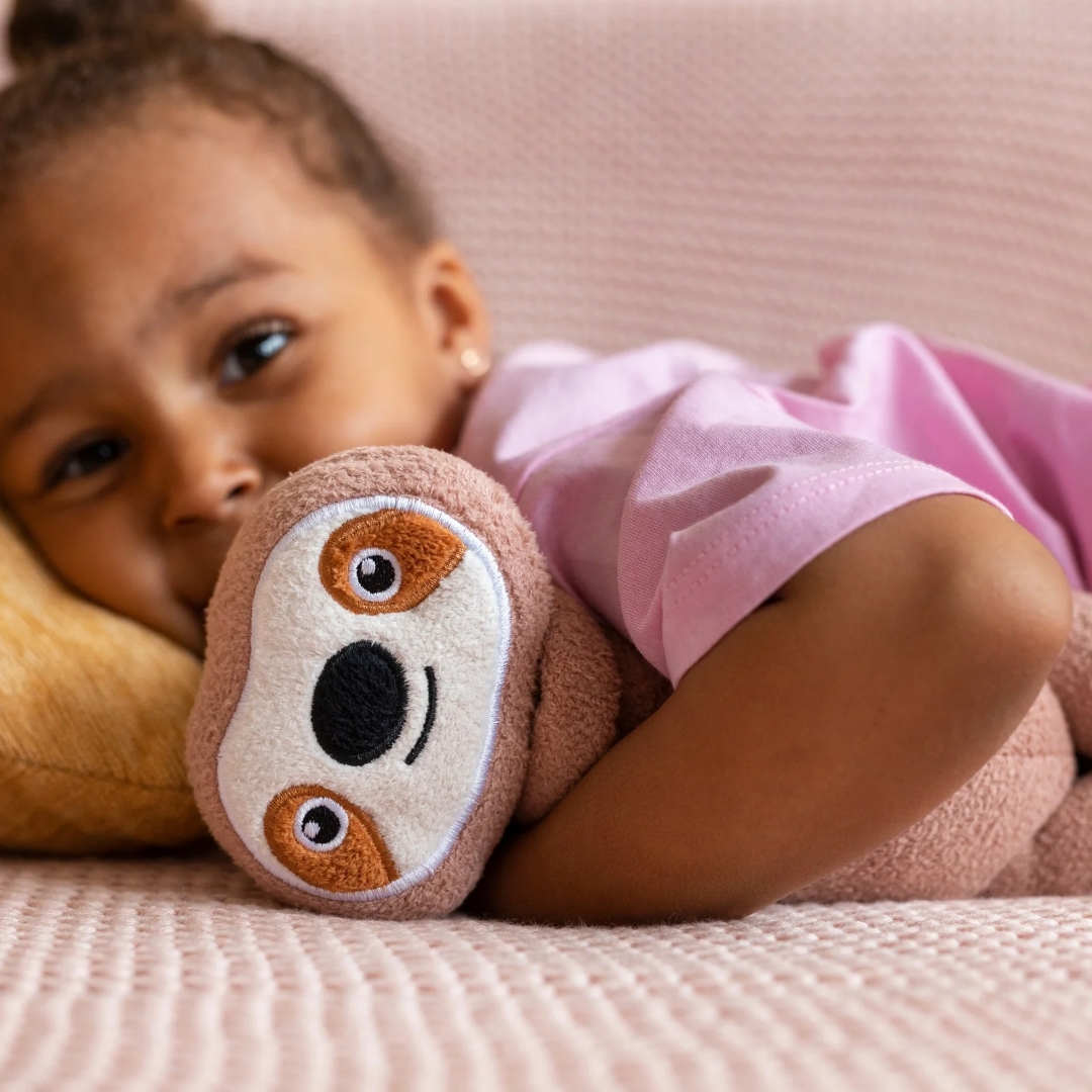 A young child resting with a soft toy